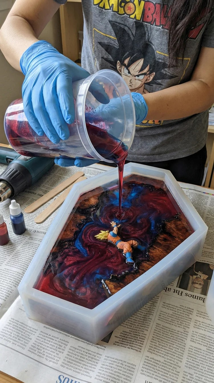 Colored resin being poured around the figure