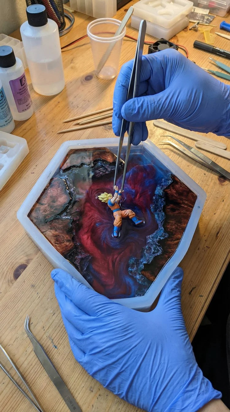 Miniature figure being placed into the resin mold